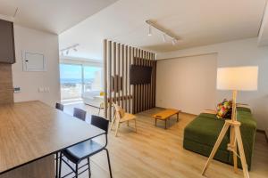 a living room with a green couch and a table at Old Town 63 Luxury Residence in Paphos