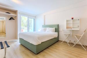 a bedroom with a bed and two chairs in it at Old Town 63 in Paphos