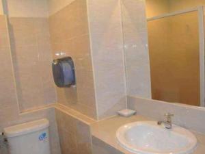 a bathroom with a sink and a toilet and a mirror at Supak Hotel in Kalasin +41 photos
