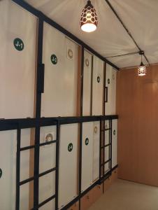 a row of lockers in a room with two lights at Lowfare Hotels Bengaluru in Bangalore +29 photos