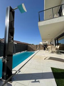 a patio with a swimming pool and a house at Villa Quartura in Kornić