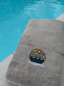 a sticker on a towel next to a swimming pool at Villa Quartura in Kornić +3 photos
