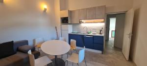 a small kitchen with a table and chairs in a room at Apartments BEVANDA in Šimuni
