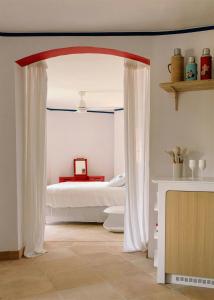 a bedroom with a bed with white curtains in it at Exceptional Apartment In Cannes' Countryside in Spéracèdes