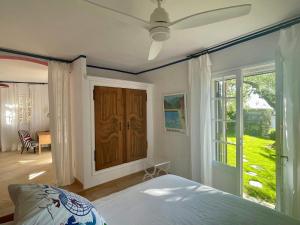 a bedroom with a bed and a ceiling fan at Exceptional Apartment In Cannes' Countryside in Spéracèdes +12 photos