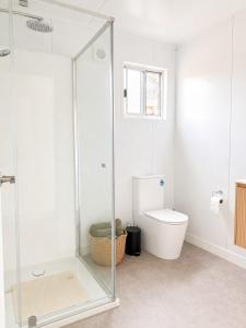 a bathroom with a glass shower and a toilet at Gem on Matrix - Hidden Retreat with Deck in Lightning Ridge +8 photos