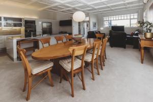 a kitchen and dining room with a wooden table and chairs at The Front Office - charming 3BR heritage home in New Plymouth