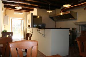 a kitchen with a counter and a table and chairs at Locanda della Corte in Roccamorice