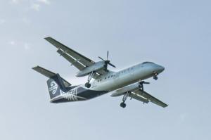 an airplane is flying in the sky at The Window Seat - pet-friendly 1BR apartment in Waitara