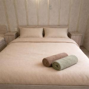 a large bed with two rolled towels on it at Andya in Constanţa +13 photos