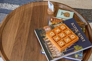 a wooden table with a book and a game on it at Naki Nook - Accommodation Stratford in Stratford