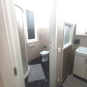 a bathroom with a toilet and a sink at La Stanza nella corte in Bollate +2 photos