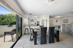 a kitchen and dining room with a table and chairs at Seven By The Sea - stylish apartment near port in New Plymouth