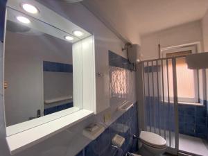 a bathroom with a mirror and a toilet in it at B&b Kamaraton in Marina di Camerota +61 photos