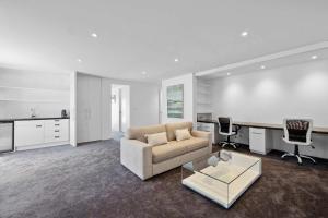 a living room with a couch and a desk at Seaview on Findlay in New Plymouth