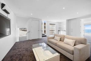 a living room with a couch and a coffee table at Seaview on Findlay in New Plymouth