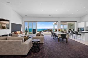 a living room with a couch and a table at Seaview on Findlay in New Plymouth +13 photos