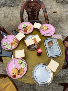 a table with plates of food on top at HOSTEL ANIMAL LOvE in Sauraha