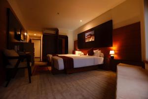 a hotel room with a bed and a desk at Resort Thim -Dorji Paro RiverFront in Paro