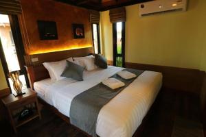 a bedroom with a large bed with two pillows on it at Lana Hotel in Chiang Mai +28 photos
