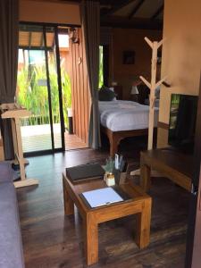 a living room with a bed and a coffee table at Lana Hotel in Chiang Mai