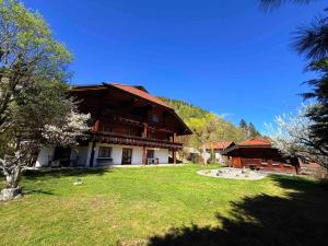a large building with a grass yard in front of it at LUXURY Biochalet Charles in Bad Kleinkirchheim