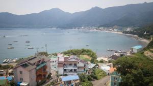 a view of a beach with boats in the water at Geoje Ocean Love Pension in Geoje