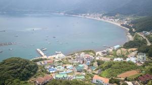 an aerial view of a town with boats in the water at Geoje Ocean Love Pension in Geoje