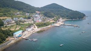 an aerial view of a harbor with boats in the water at Geoje Ocean Love Pension in Geoje