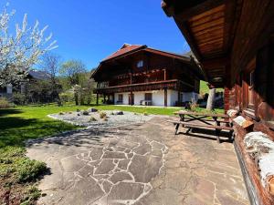 a house with a picnic table in front of it at LUXURY Biochalet Charles in Bad Kleinkirchheim