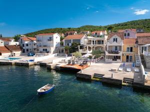 a small boat in the water in a harbor at Dubravcevic Residence in Tivat +74 photos