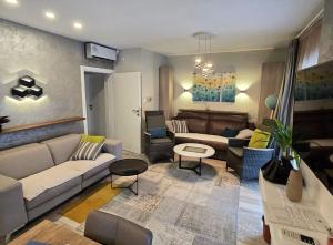a living room with a couch and a table at Apartments Villa Vera in Tivat