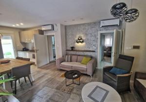 a living room with a couch and a table at Apartments Villa Vera in Tivat