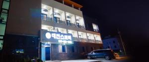 a car parked in front of a building at night at Daecheon Story Pension in Boryeong