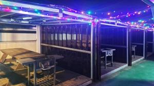 a bar with a wooden table and lights on it at Daecheon Story Pension in Boryeong