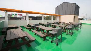 a group of tables and chairs on a roof at Daecheon Story Pension in Boryeong +5 photos