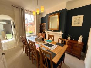 a dining room with a table and chairs and a mirror at Number 29 in Melcombe Regis