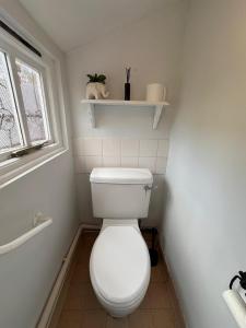 a bathroom with a white toilet and a window at Number 29 in Melcombe Regis