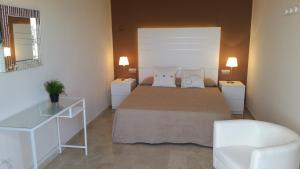 Postel nebo postele na pokoji v ubytování Hotel L'Alguer