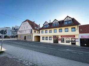 a street with two buildings on the side of a road at FlyInn-Pension Airport-Messe in Leinfelden-Echterdingen