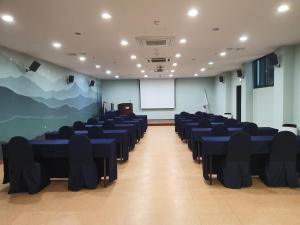 a conference room with blue tables and chairs at Aewol Stay in Jeju Hotel&Resort in Jeju +85 photos