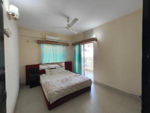 a bedroom with a bed and a window at Hotel World Beach Resort in Cox's Bazar