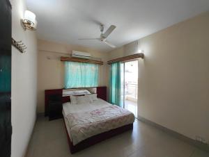 a small bedroom with a bed and a window at Hotel World Beach Resort in Cox's Bazar