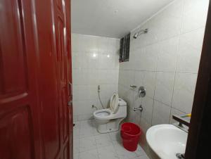 a small bathroom with a toilet and a sink at Hotel World Beach Resort in Cox's Bazar