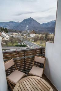 two chairs on a balcony with a view of a mountain at Apartments and Rooms Skok in Bovec