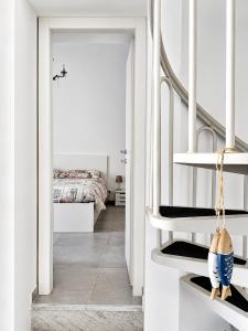 a bedroom with a bed and a hallway with white walls at Ca' Du Marchin, Noli. in Noli