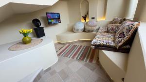 a living room with a couch and a tv at Betham Chalet in Nizwa
