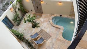 an overhead view of a swimming pool in a building at Betham Chalet in Nizwa