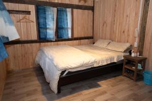 a bedroom with a bed and a window and a table at Nùng Indigo in Cao Bằng