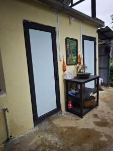a door to a building with a table next to it at Nùng Indigo in Cao Bằng